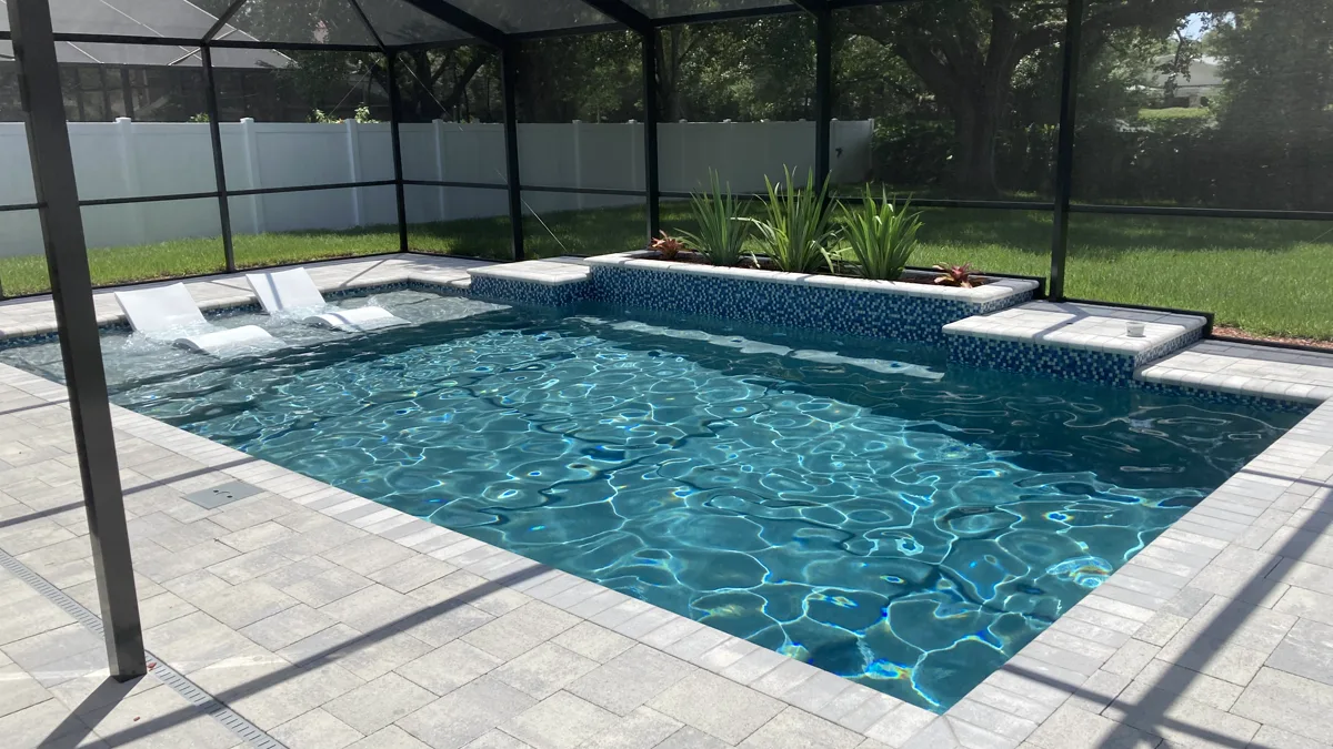 Screen-enclosed geometric pool with raised spa and blue mosaic feature, Odessa FL