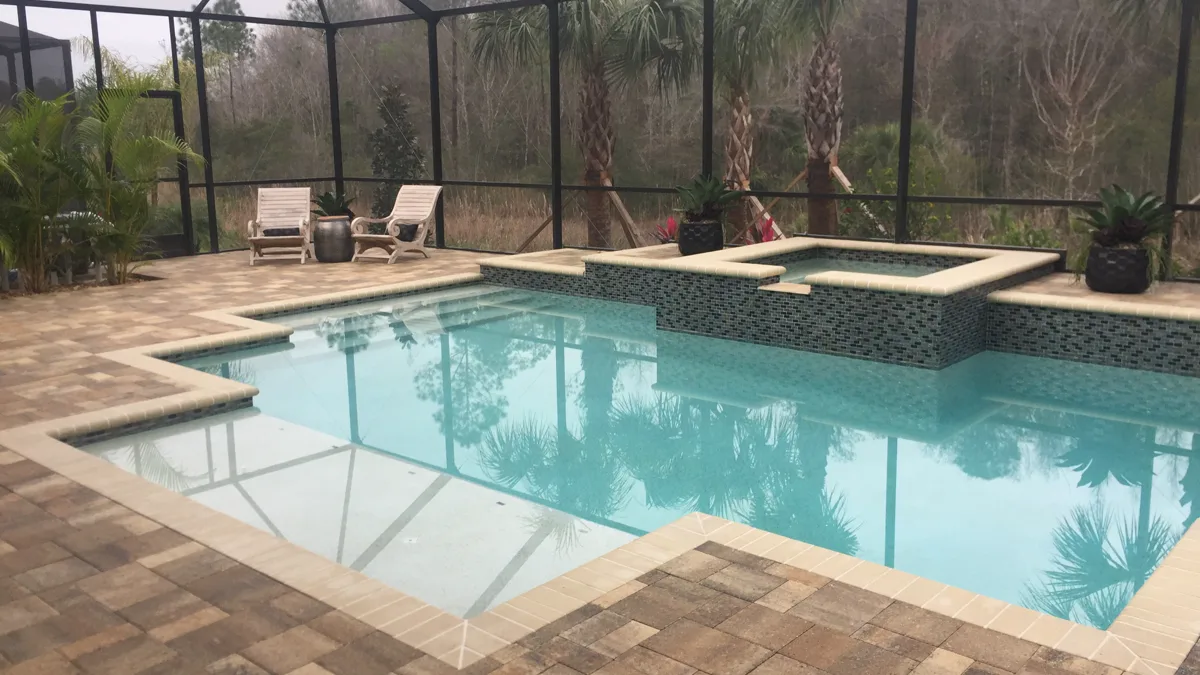 Screen-enclosed pool with spa, paver deck, palms, and Adirondack chairs, Pasco County FL