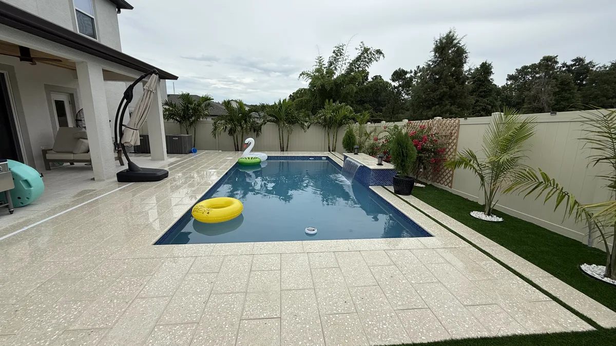 Rectangular pool with blue mosaic spa and manicured yard, Pasco County FL