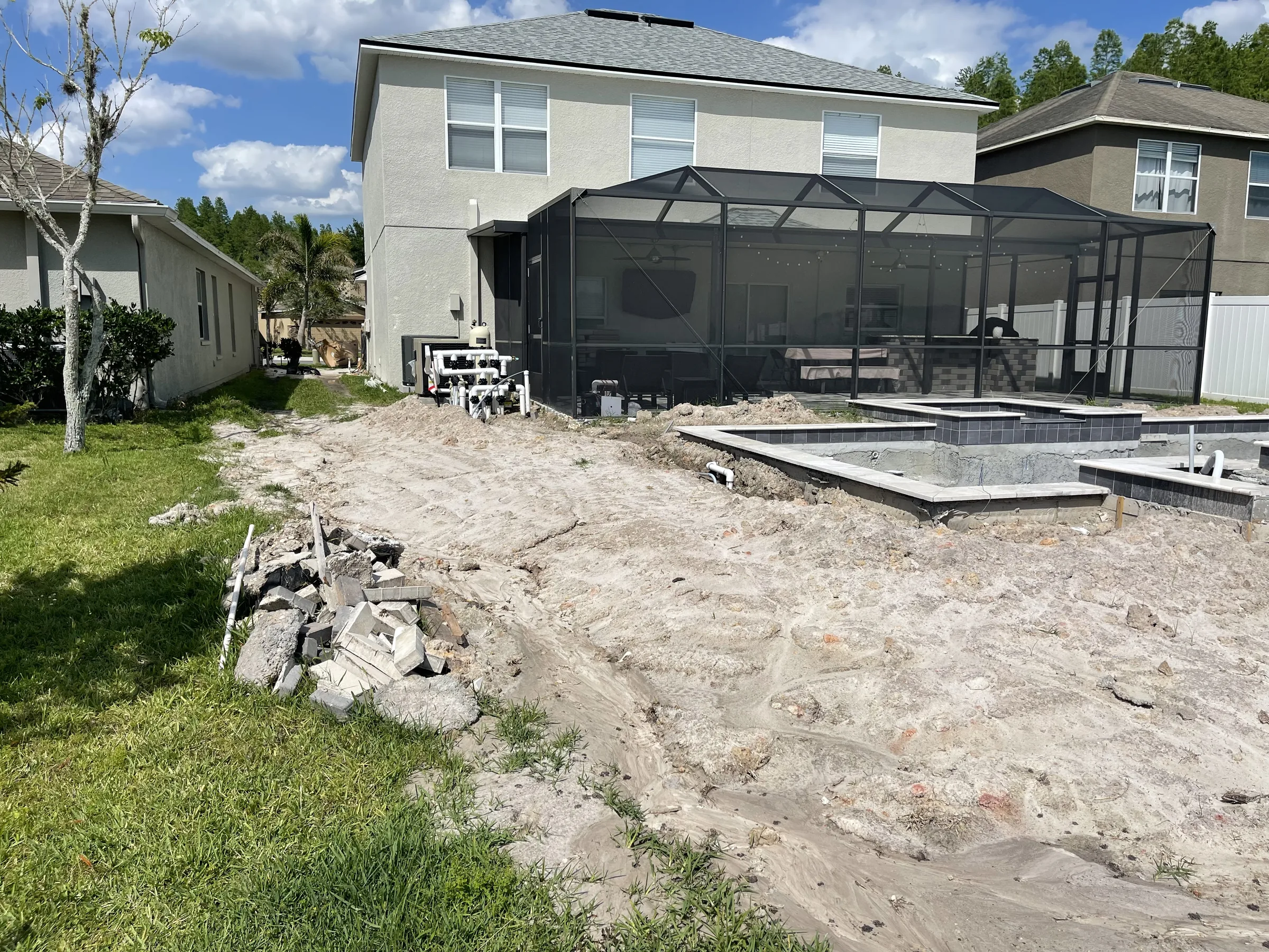 Shell with tile and coping being set on raised spa, Trinity FL