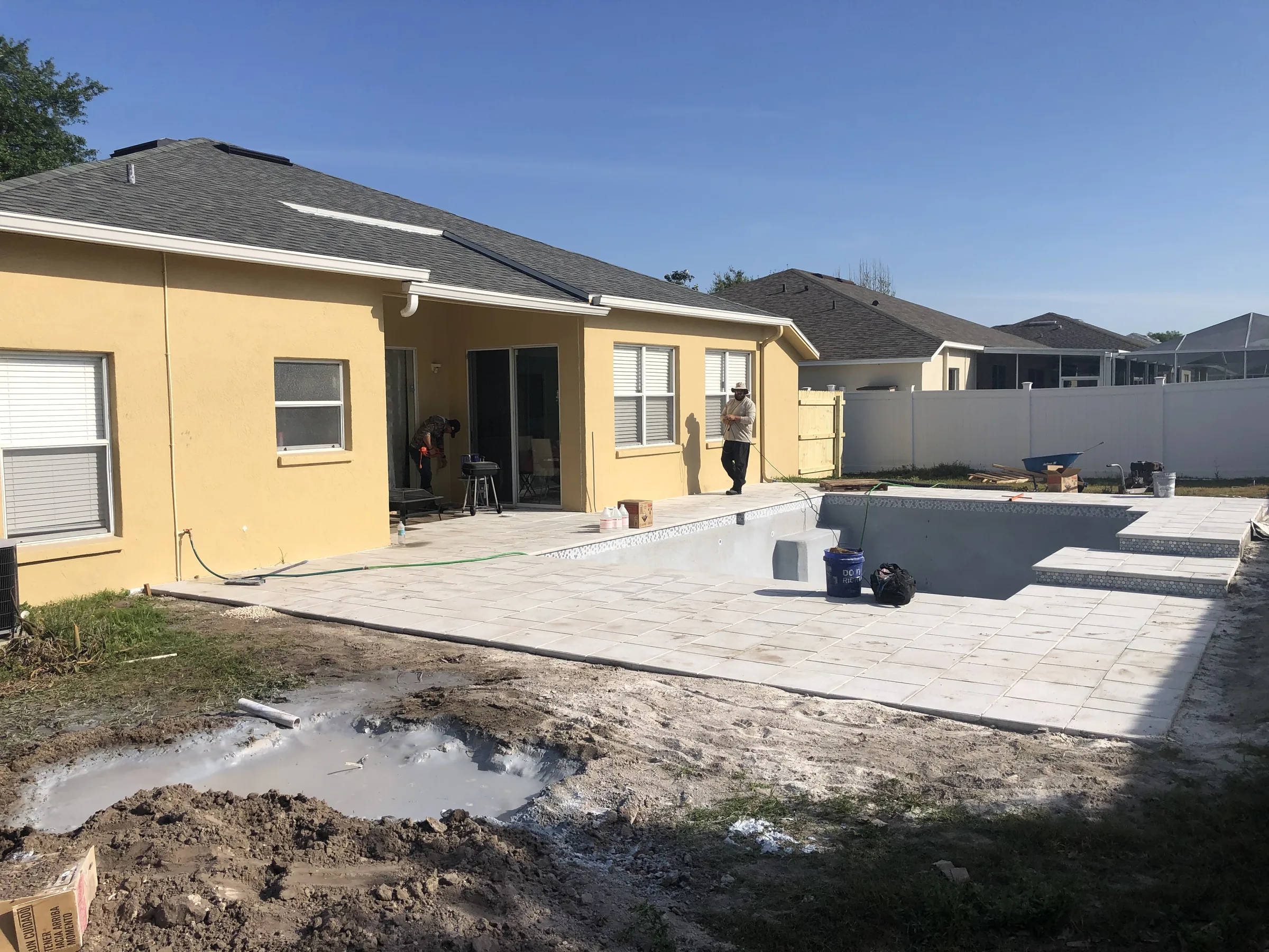 Paver deck installed around empty pool shell pre-finish, Tampa FL