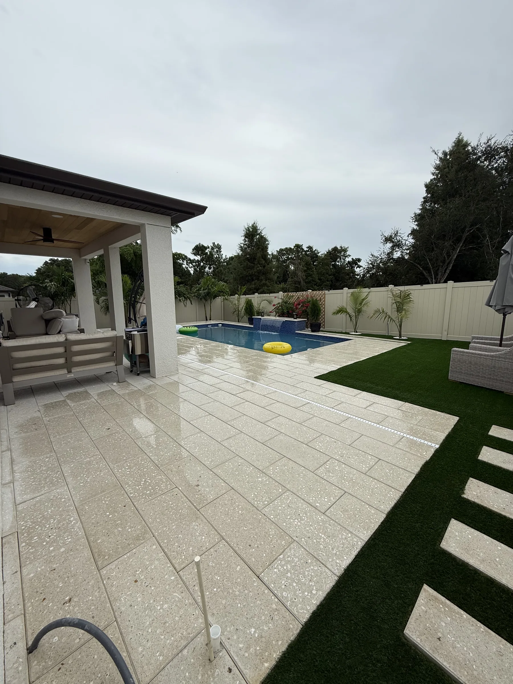 Rectangular blue pool with paver deck and landscape border, Trinity FL