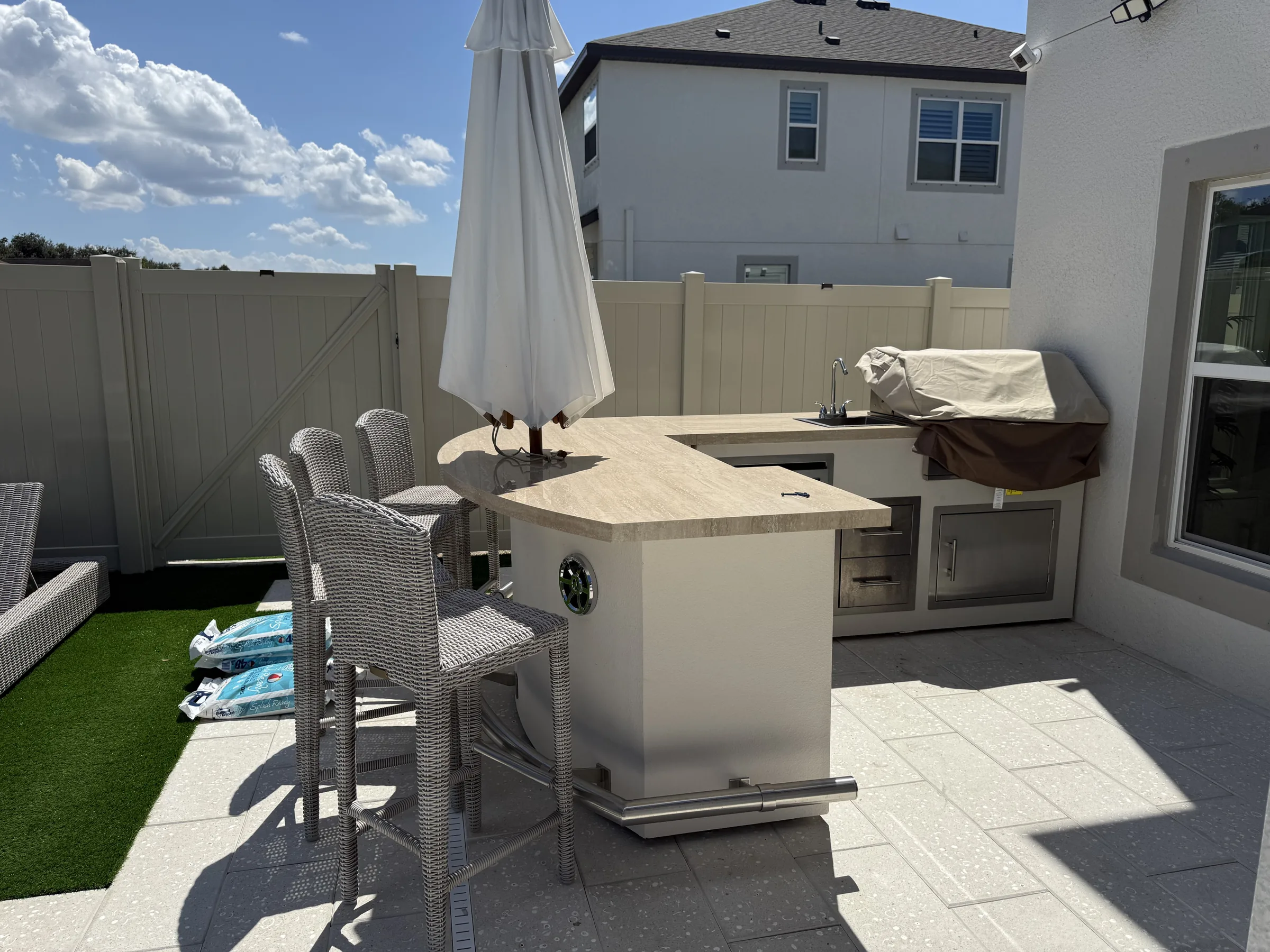 Outdoor kitchen with bar seating and paver patio, Wesley Chapel FL