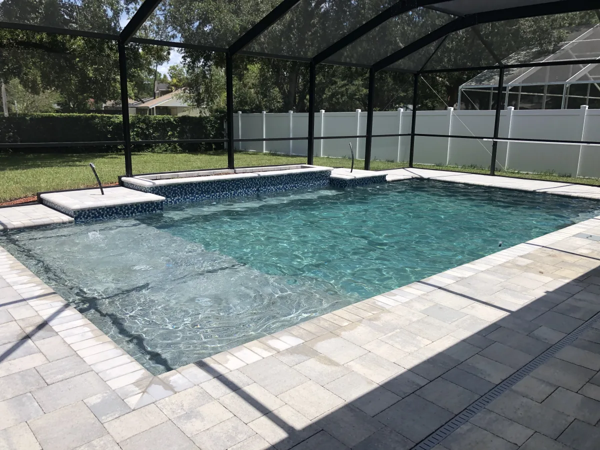 Geometric pool with sun shelf, spa, and travertine deck, Trinity FL